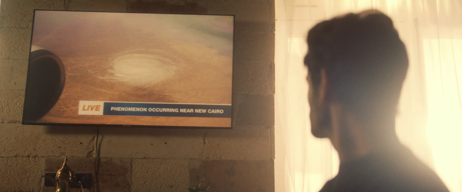 a man standing in front of a television in a living room