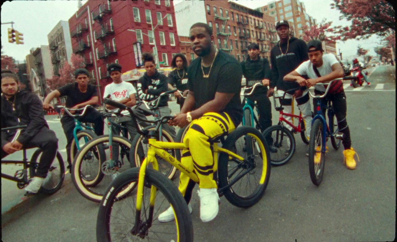 a group of men riding bikes down a street