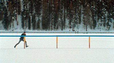 a person walking across a snow covered field