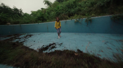 a woman in a yellow jacket is walking in the rain