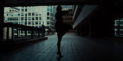 a woman standing in the middle of a walkway