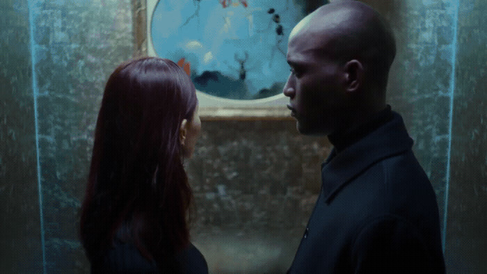 a man and a woman standing in front of a mirror