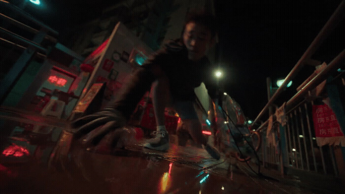 a man riding a skateboard down a street at night