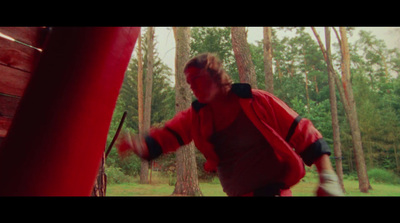 a man in a red jacket holding a red frisbee