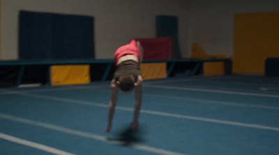 a person doing a handstand on a blue track