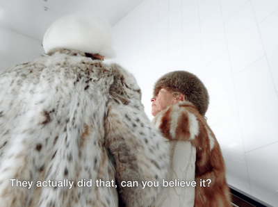 a man in a fur coat looking at another man in a fur coat