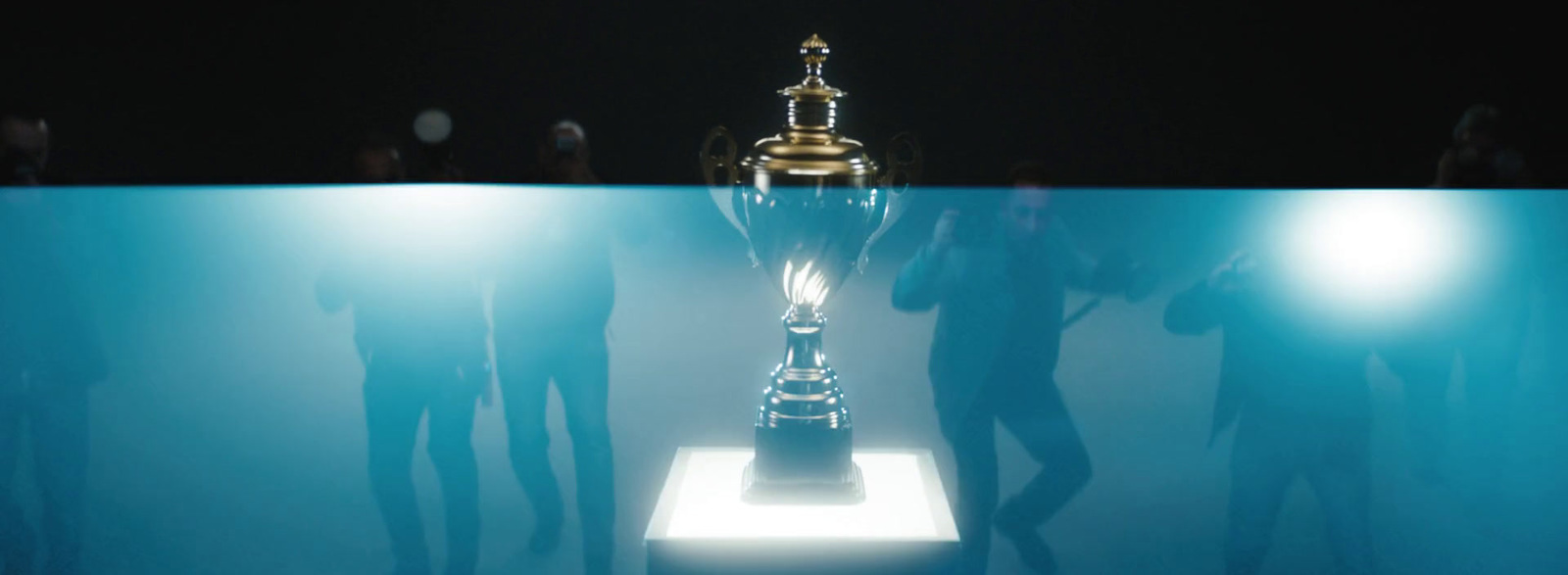 a group of people standing around a trophy