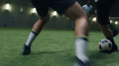 a close up of a person kicking a soccer ball