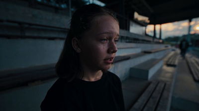 a woman standing in front of a train station