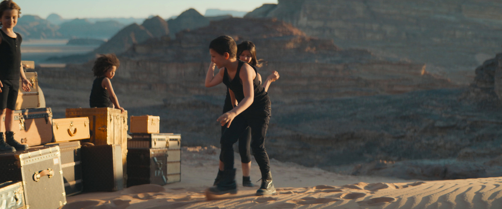 a group of people standing on top of a desert