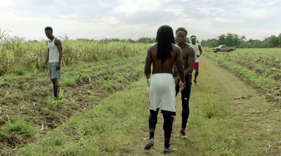 a group of people walking down a dirt road