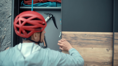 a man wearing a red helmet holding a wrench