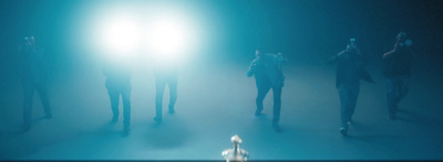 a group of people standing in a dark room