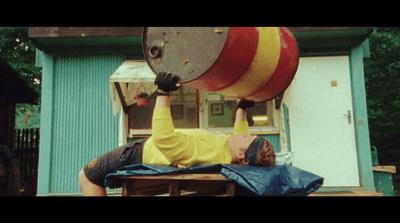 a man holding a large metal bucket over his head