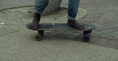 a person standing on a skateboard on a sidewalk