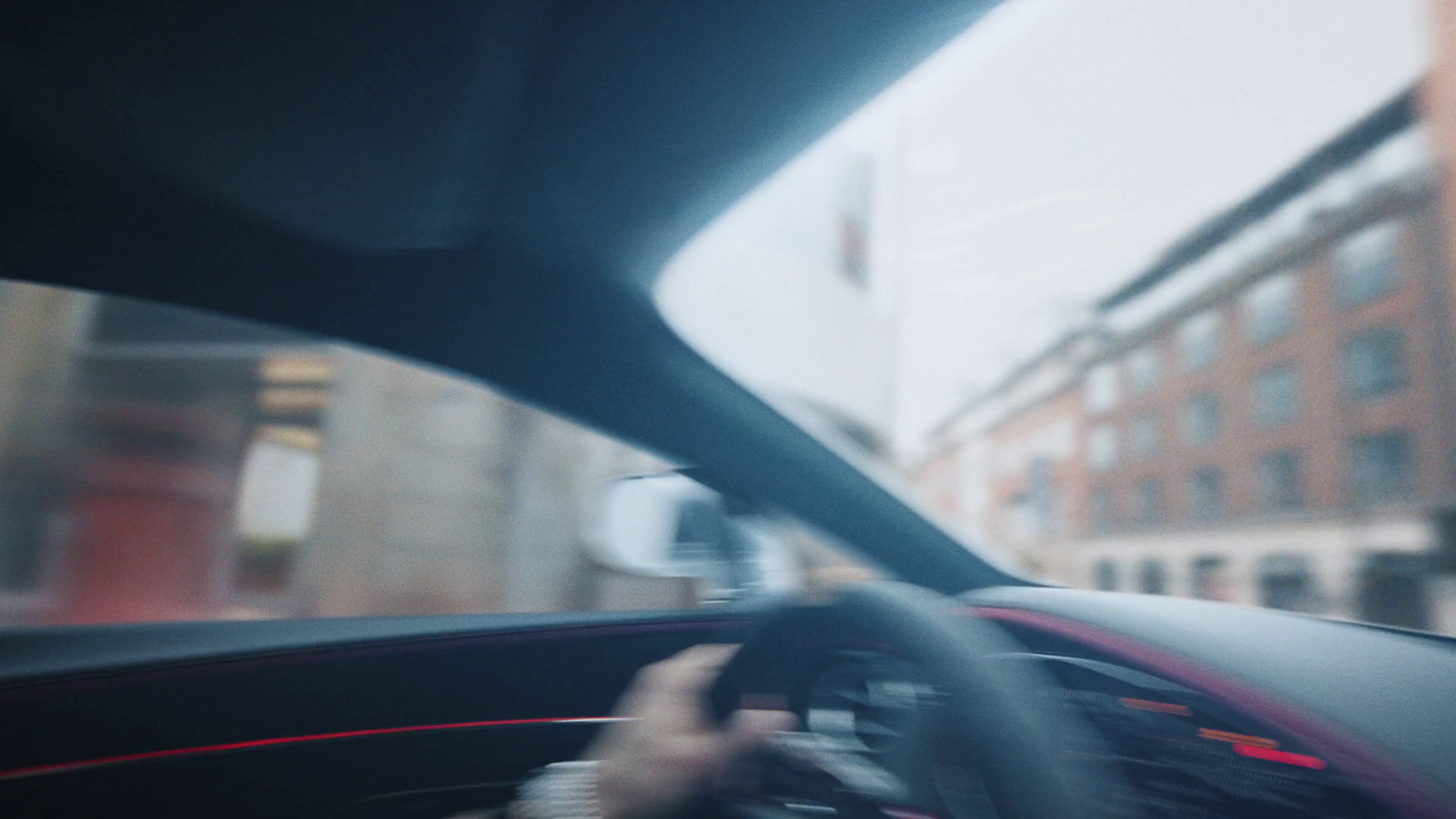 a person driving a car on a city street