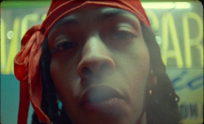 a close up of a person wearing a red bandana