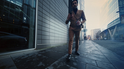 a man in a suit is walking down the street