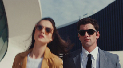 a man in a suit and tie standing next to a woman