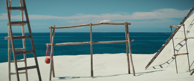 ladders and a ladder on a beach with the ocean in the background