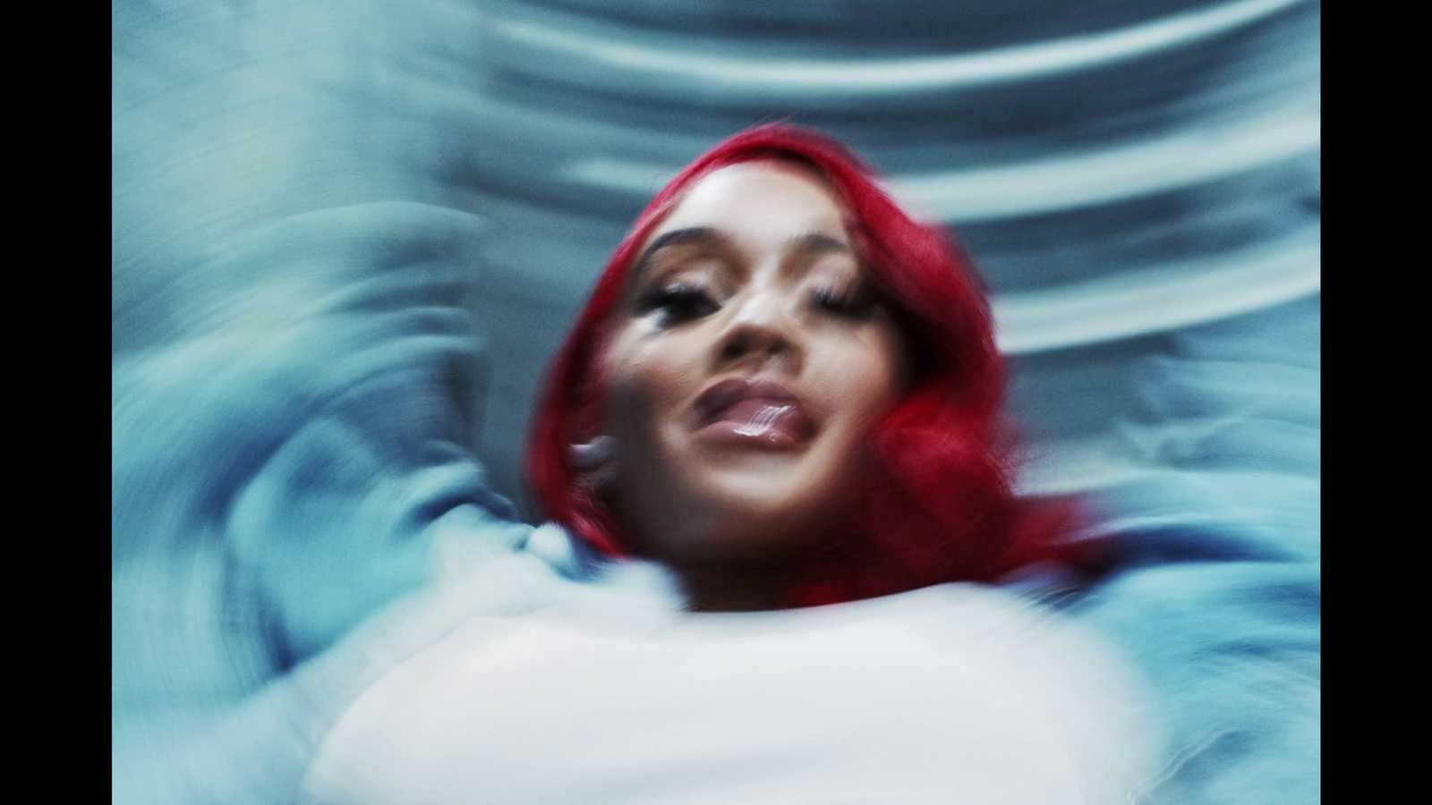 a woman with red hair is posing for a picture