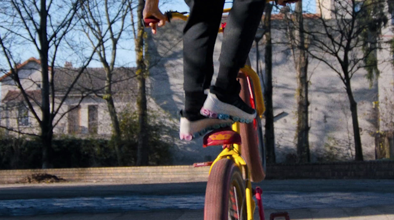 a man riding a skateboard on top of a bike