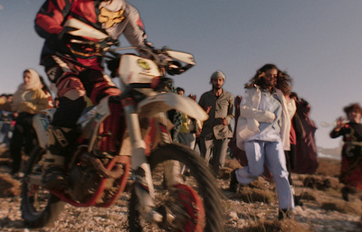 a man riding a dirt bike on top of a field