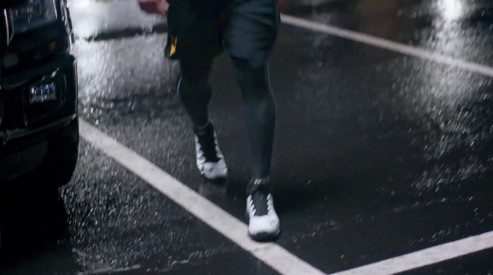 a man walking down a street in the rain