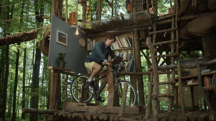 a man riding a bike on top of a wooden structure