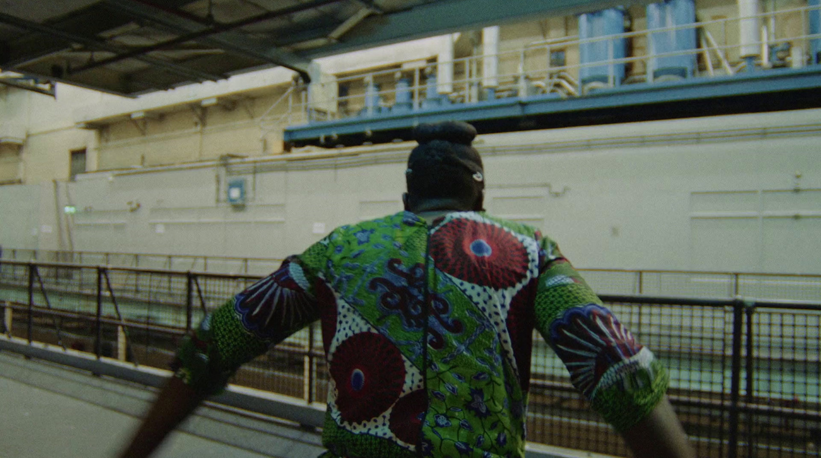 a man in a colorful shirt walking down a street