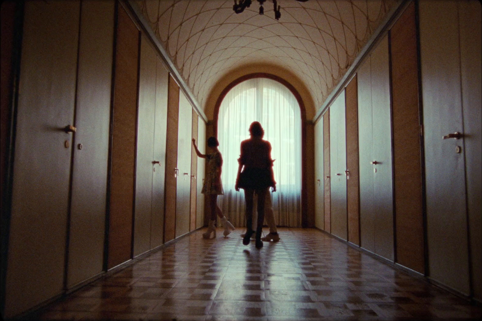 two women are standing in a hallway in a building