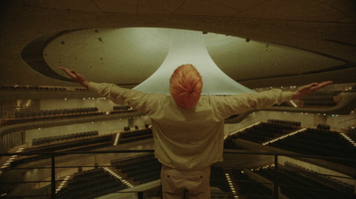 a person standing in front of a large light fixture