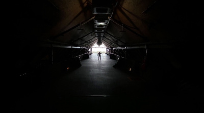 a dark tunnel with a person standing in it