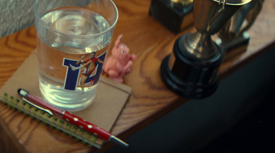 a glass of water sitting on top of a wooden table