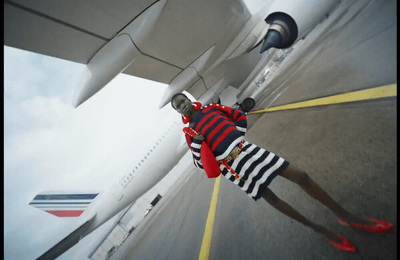 a man in striped shorts and a red and white shirt is standing in front of