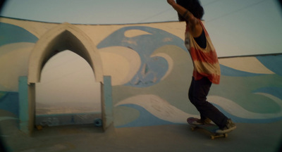 a man riding a skateboard next to a wall