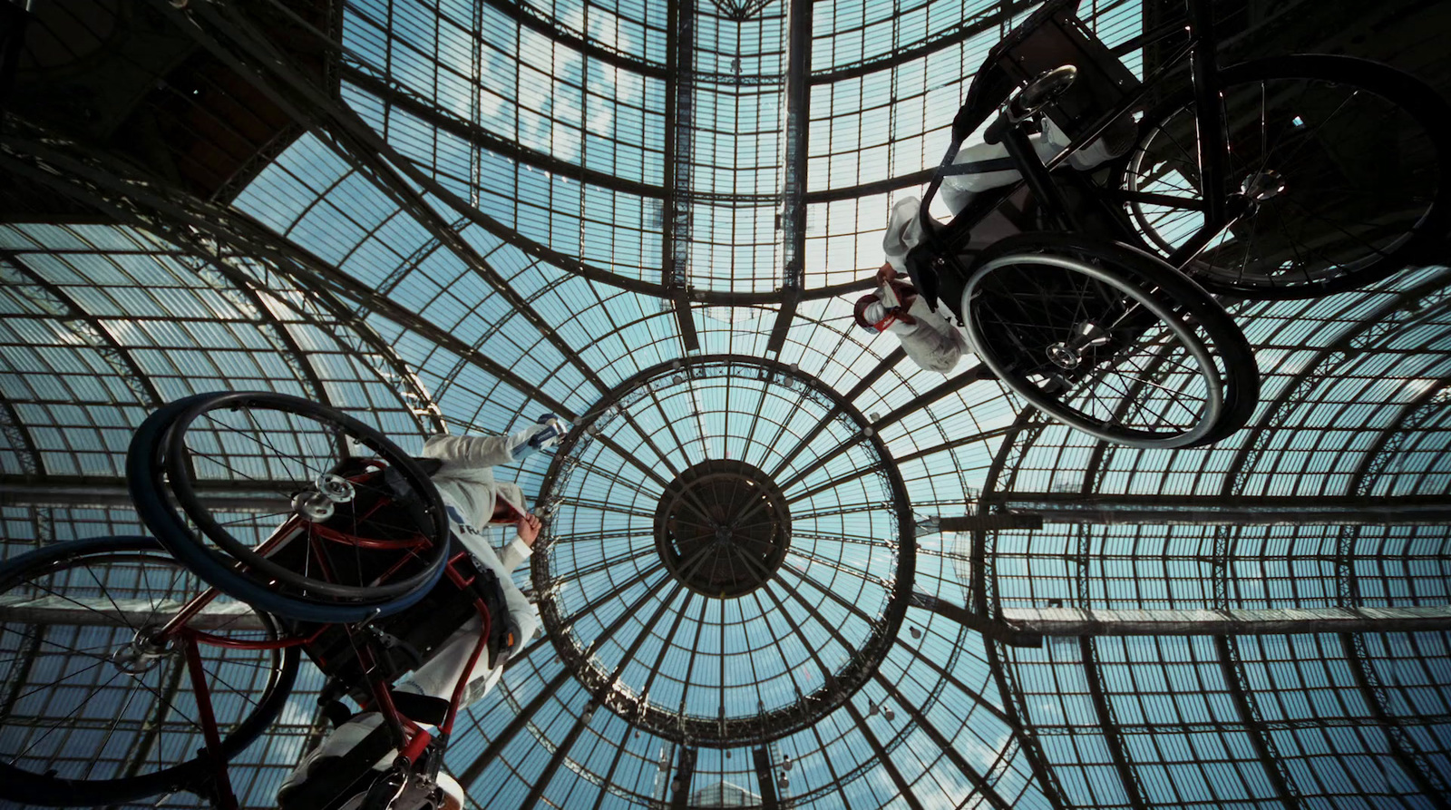 a man riding a bike up the side of a glass ceiling