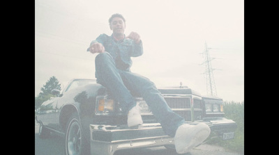 a man sitting on the hood of a truck