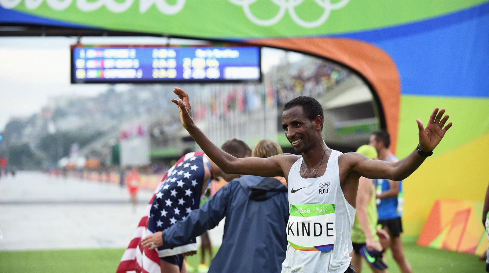 a man running in a marathon with his hands in the air