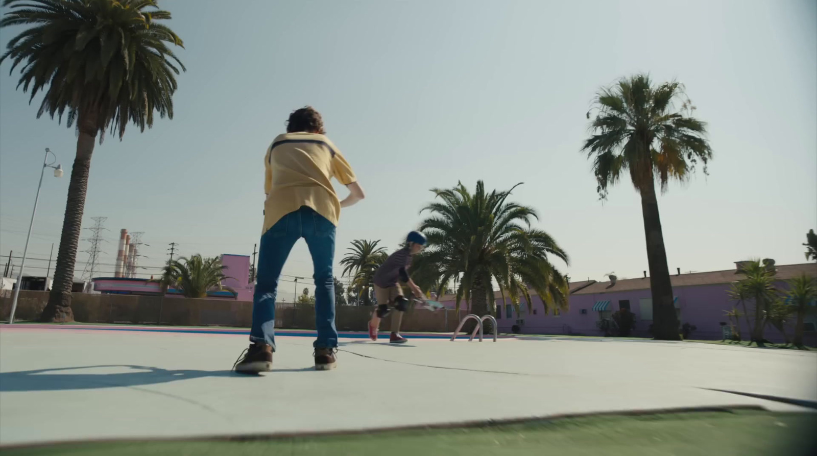 a man riding a skateboard down a cement walkway