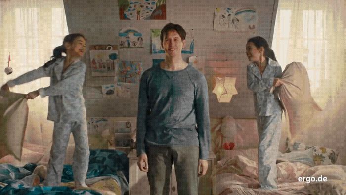 a group of people standing in a bedroom