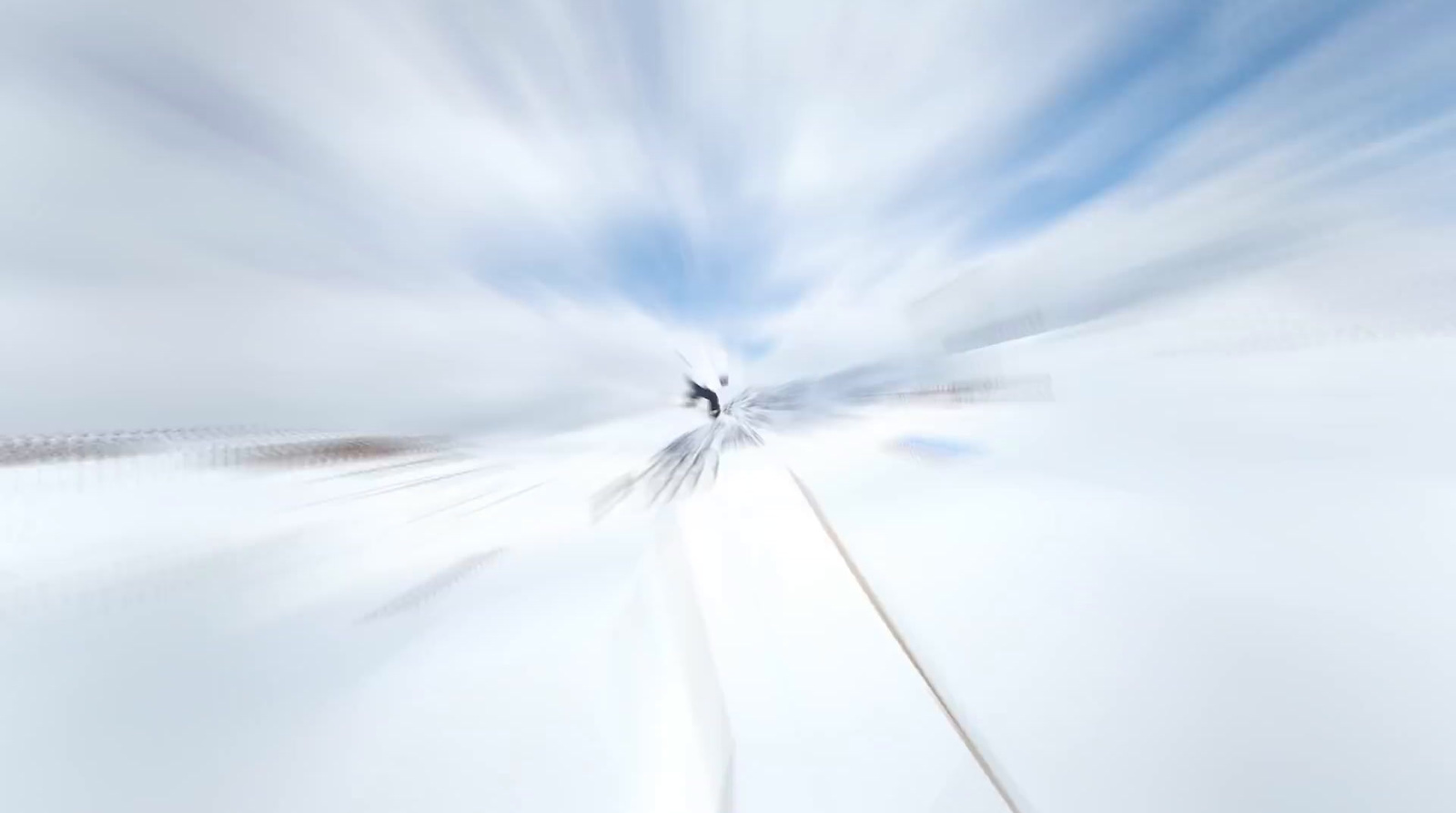 a blurry photo of a train track with a sky background