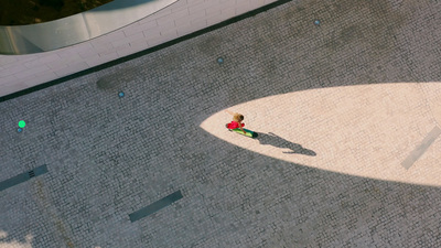 an aerial view of a person walking down a street