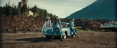 a group of people standing next to a car