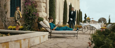 a woman in a blue dress sitting on a chair