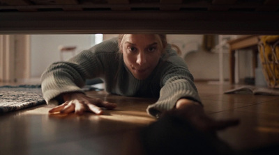 a woman laying on the floor with her hands on the floor