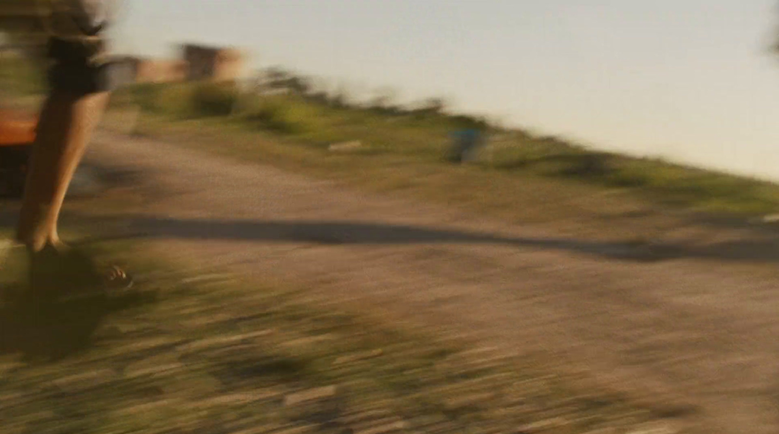 a blurry photo of a person walking down a dirt road