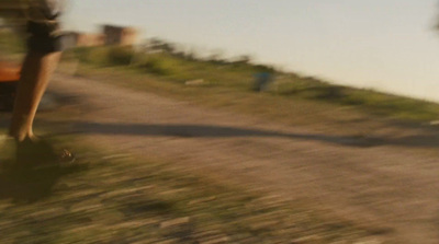 a blurry photo of a person walking down a dirt road