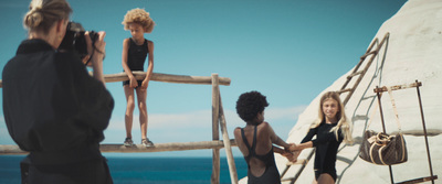 a group of women standing on top of a wooden bridge