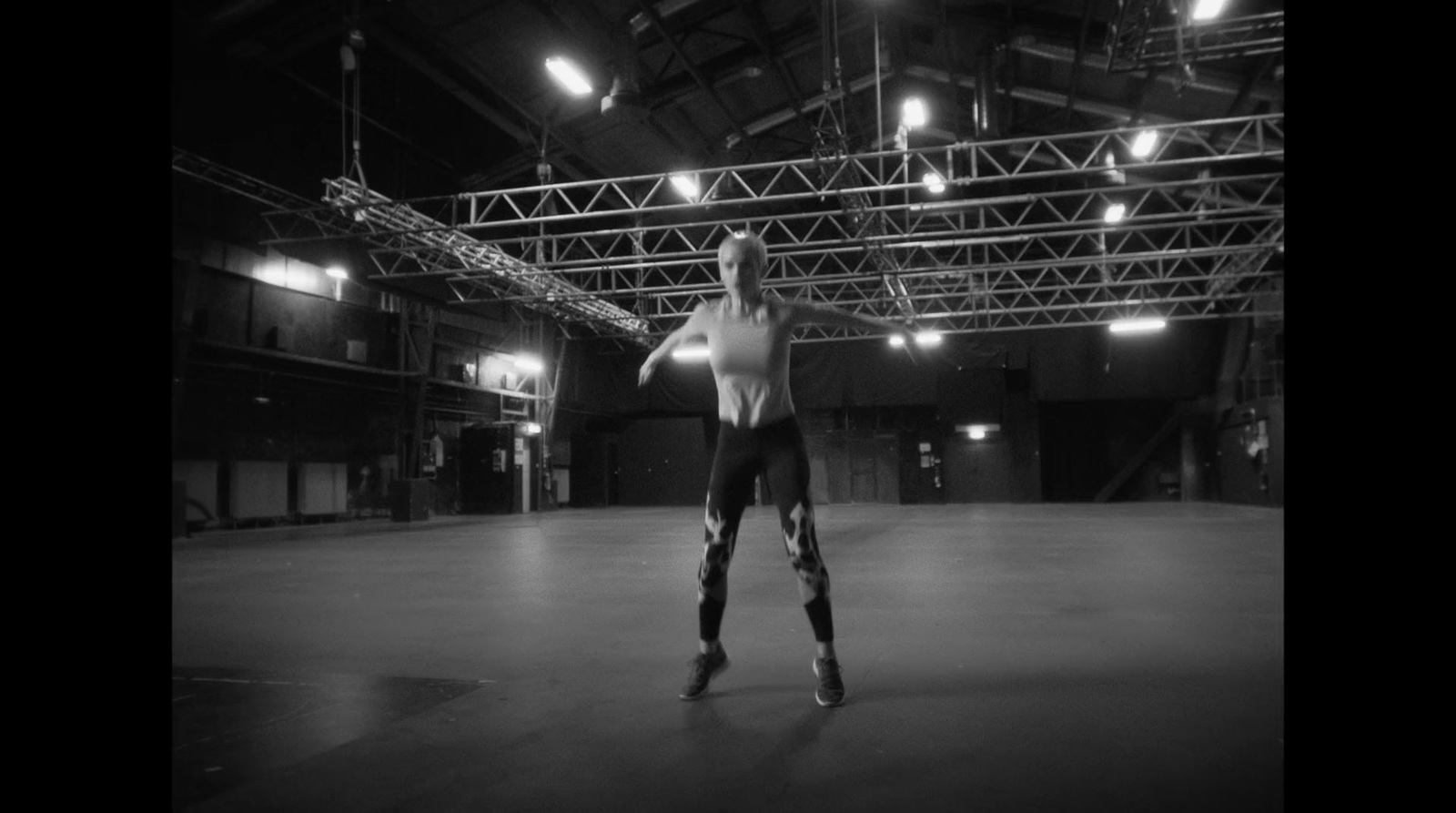 a man standing in a large room with lights on